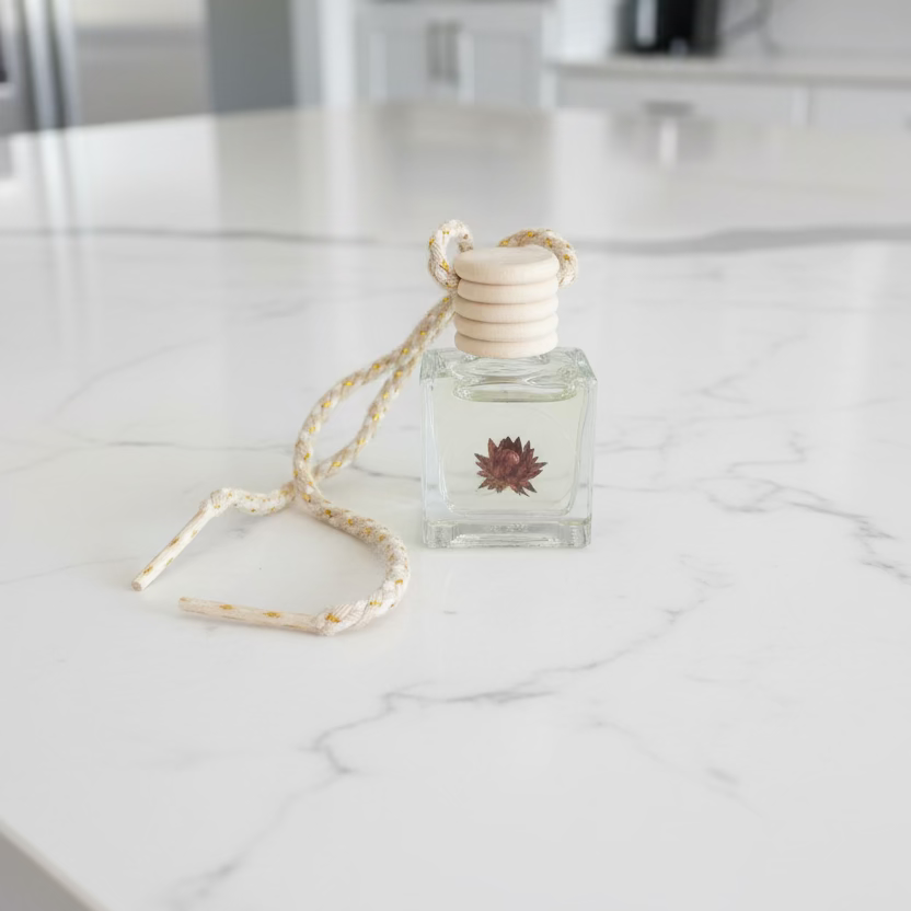 Small glass bottle with a cork stopper on a dark surface