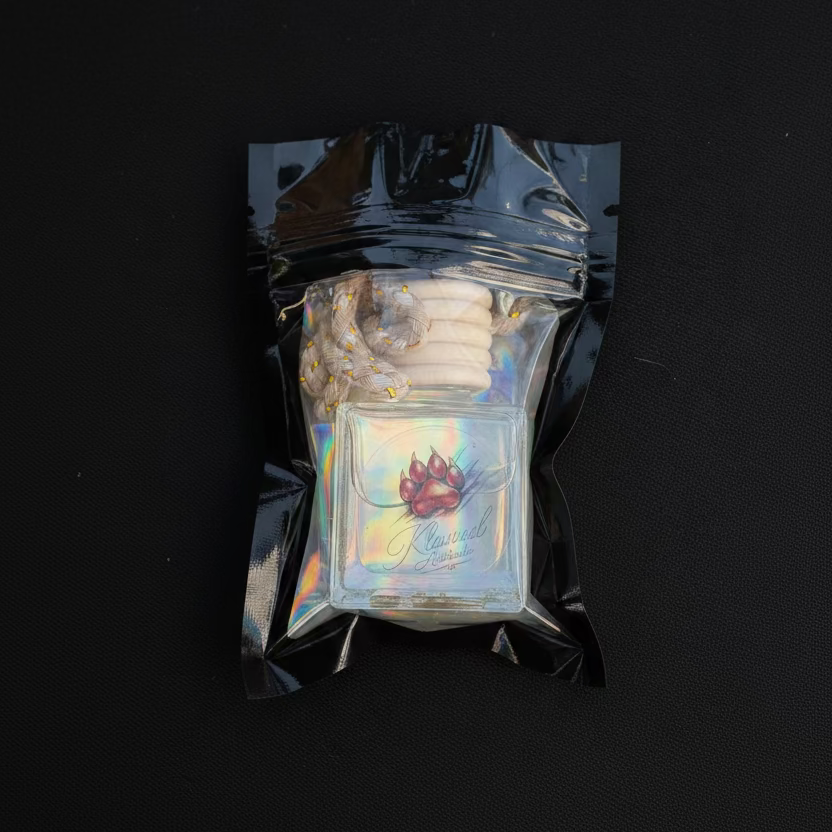 Iridescent glass pipe in a clear plastic packaging on a dark surface