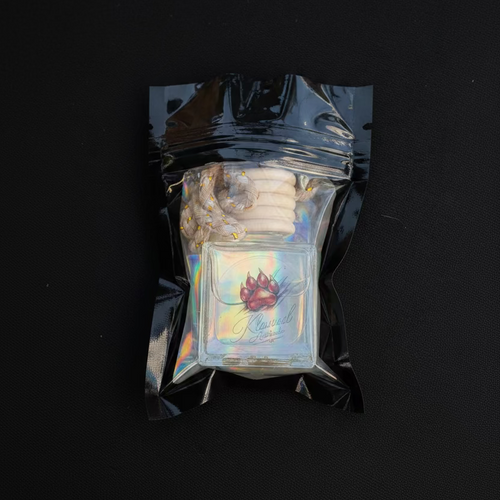 Iridescent glass pipe in a clear plastic packaging on a dark surface