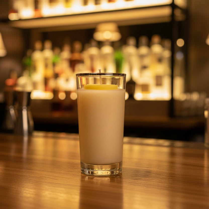 Candle in a glass container on a wooden surface
